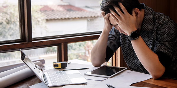 looking at financial statements with head in hands